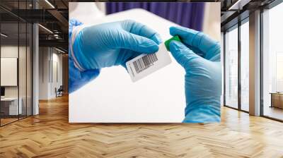 Closeup of a nurse labelling a test tube with blood sample in a clinical laboratory Wall mural