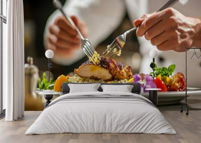 Chef plating a meal with a fork. Wall mural