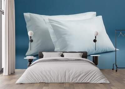 Two white pillows against a blue background. Wall mural