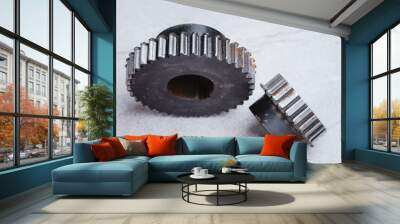 Old gear worn out, chipped gears on cement background. Concept of engineering spare part. Wall mural