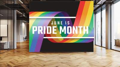 June is pride month text in white frame cross rainbow pride flag with rolling and waving on black background vector design Wall mural