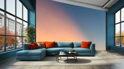 The evening sky simple background the orange light of the sun shading against the blue sky Wall mural