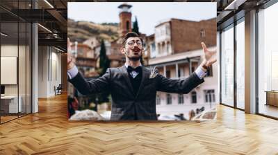 Georgian from Tbilisi, a stylish man expressively talks about local hospitality in Georgia, invites you to stroll through the old streets and taste the local cuisine. To promote tourism Wall mural