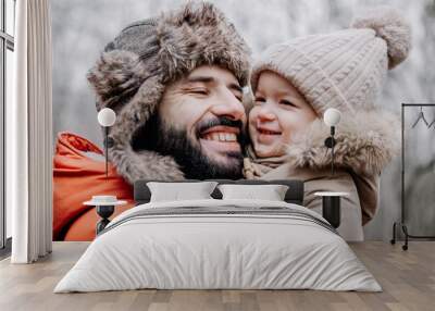 Portrait of happy family: Father and baby daughter on Winter Vacation in park. Happy, joyful family. Wall mural