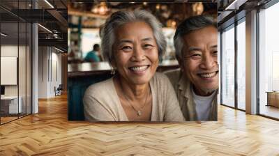 portrait of a mature asian couple smiling in a restaurant outside on vacation, taking a selfie, concept of enjoyment in old age, space for text Wall mural