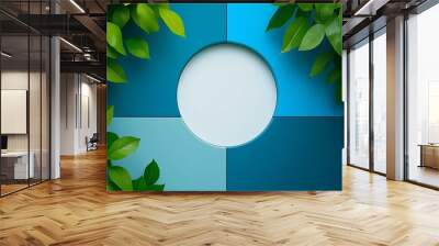 A circular white frame surrounded by green leaves and blue squares. Wall mural