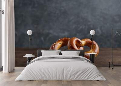 Two Golden-Brown Pretzels with Sesame Seeds on Dark Gray Backdrop Wall mural