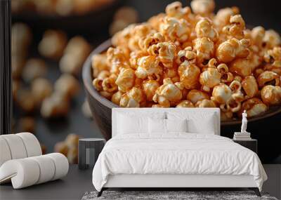 A bowl of golden, crunchy caramel popcorn on grey background Wall mural