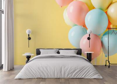 A bunch of pastel colors balloons on the yellow background. Birthday balloons. Celebration balloons. Wall mural