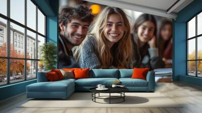 A group of students smiling as they study together, surrounded by textbooks and notebooks. Wall mural