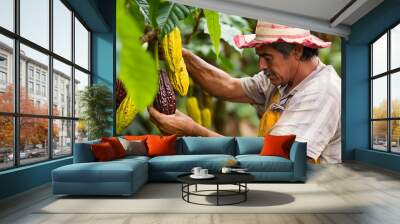 A venezuelan cacao farmer carefully harvests ripe cacao pods in a lush plantation surrounded by vibrant green leaves Wall mural