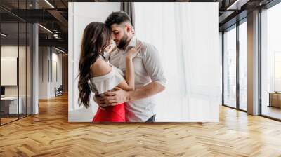 boyfriend kisses girlfriend at home in apartment Wall mural