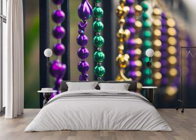 Close-up of vibrant traditional Mardi Gras beads in purple, green, and gold arranged in a decorative display highlighting festive colors Wall mural