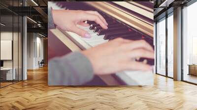 Closeup view of hands playing the piano (shallow depth of field) Wall mural