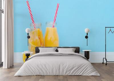 Glass bottles with orange juice and detox water. Wall mural