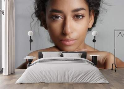 happy serene young woman with beautiful olive skin and curly hair ideal skin and brown eyes Wall mural