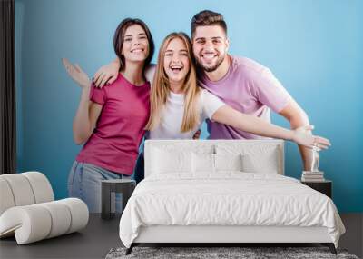 happy three friends man and women on blue background Wall mural