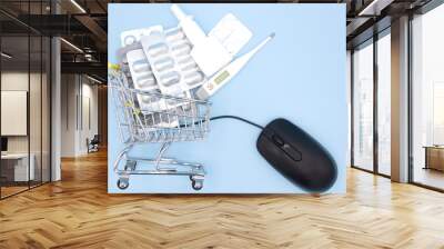 Medicines in shopping cart in drugstore with mouse to online order on blue background. Online Pharmacy. Buying Medicine. idea for health insurance. Wall mural