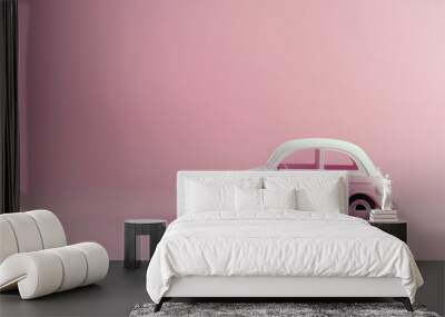 Miniature pink car on a pink background. Buying a car, new car.  Wall mural