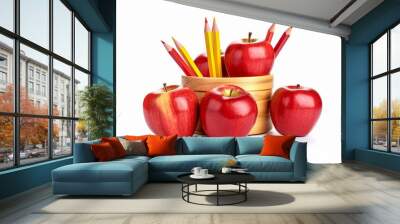 A group of red apples and pencils in a wooden bowl isolated on a white background Wall mural