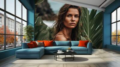 portrait of a woman with tropical leaves on the ocean coast Wall mural