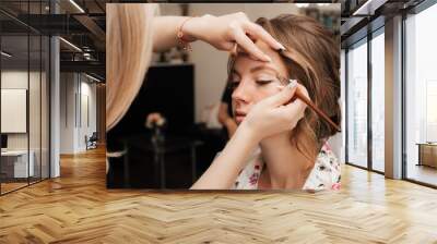 Shooting in a beauty salon. makeup artist prepares the bride before the wedding in the morning Wall mural