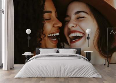 Two women share a joyous moment, laughing together with genuine smiles, showcasing their close friendship and happiness Wall mural