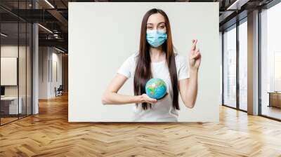 woman praying for planet earth globe wearing mask isolated on white background Wall mural