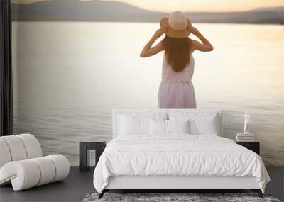 young girl on the beach in a hat Wall mural