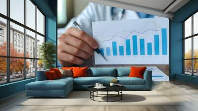 a male doctor presenting a graph on health insurance business growth. concept healthcare, insurance, Wall mural