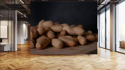 A pile of dried peanuts in shell close up. Healthy protein food Wall mural