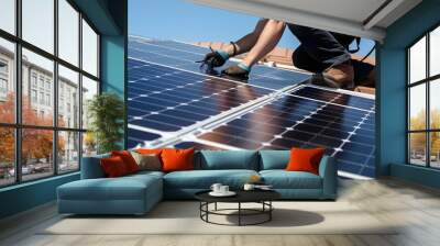 A worker installs solar panels on the roof of a house Wall mural