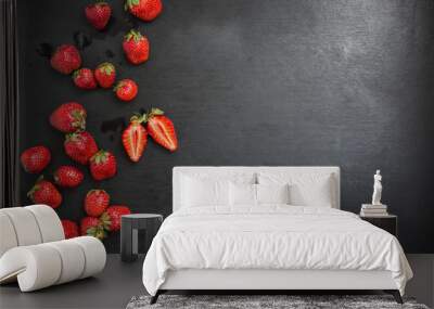 top view copyspace, strawberries cut into pieces on black backgr Wall mural