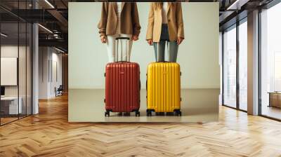 Cropped view of  two girls standing near red and yellow luggages near white wall, travel holiday concept, copy space, trip advertising Wall mural