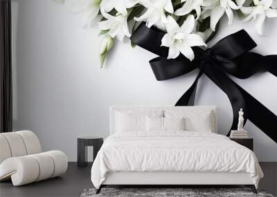 Funeral symbols. White flower near black ribbon on white background top view space for text Wall mural