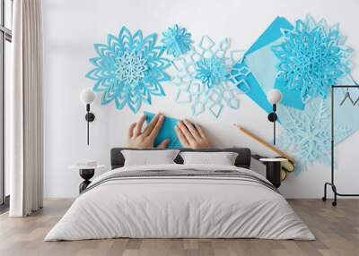 Making of snowflakes from paper. A traditional Christmas arts and crafts project Wall mural