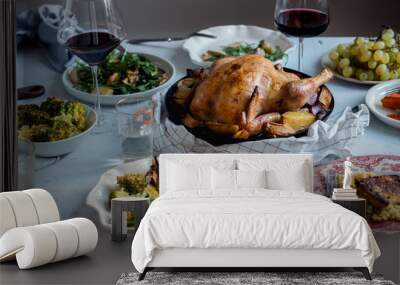 Big festive dinner with roasted chicken, wine and various garnishing. Celebration concept Wall mural