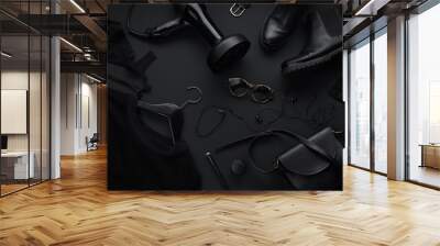 Black monochromatic flatlay on black background. Clothes, accessories and beauty equipment. Black friday sale concept Wall mural