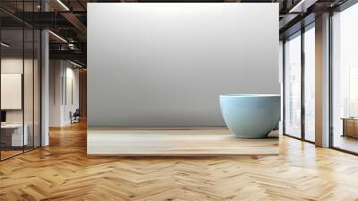 On a plain wooden table with abundant empty space a white coffee cup sits. Concept Minimalist Photography, Still Life, White Coffee Cup, Wooden Table, Empty Space Wall mural