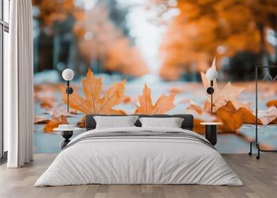 Orange maple leaves on the ground in a blurred autumn backdrop Wall mural