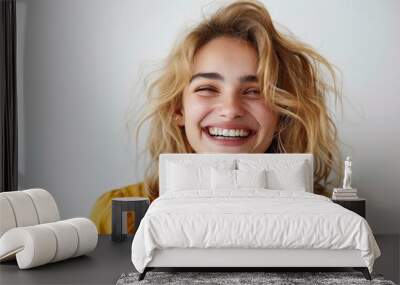 radiant young woman laughing with joyful expression Wall mural