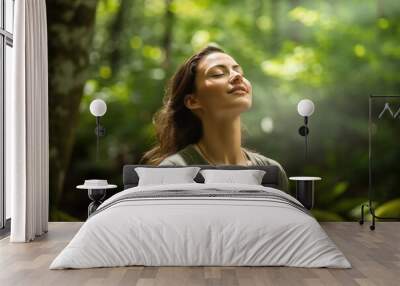 relaxed woman breathing fresh air in green forest. сoncept nature retreat, forest therapy, mindful m Wall mural