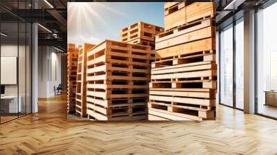 Stacks of wooden pallets are set against a clear blue sky, with the sunlight casting a warm glow over the timber used for transport and storage. AI Generation Wall mural