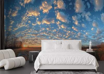 Stunning evening sky with panoramic clouds over frosty field at dusk Wall mural