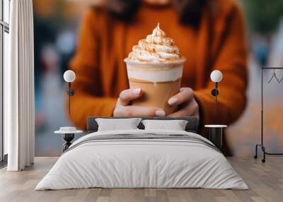 Woman Holding Frothy Pumpkin Spice Latte Outdoors. Generative AI Wall mural