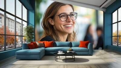 Young woman with glasses smiles warmly during a casual meeting in a cafe Wall mural