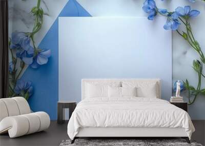 Blank card with blue envelope and blue flowers on marble surface Wall mural