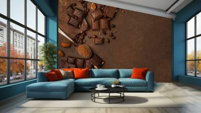 Chocolate background with chocolate pieces, chocolate chips, nuts, cocoa Wall mural