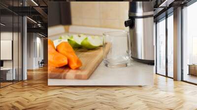 detox. smoothies. the process of making juice in the kitchen. A glass of fresh carrot juice. carrot and Apple on the table. detoxification, vegetarian diet. juicy healthy vitamin drink. juicer. Wall mural