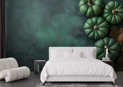 Four green pumpkins with autumn leaves on a green textured background Wall mural